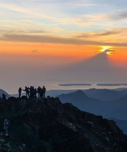 Hikers at mountain sunrise summit