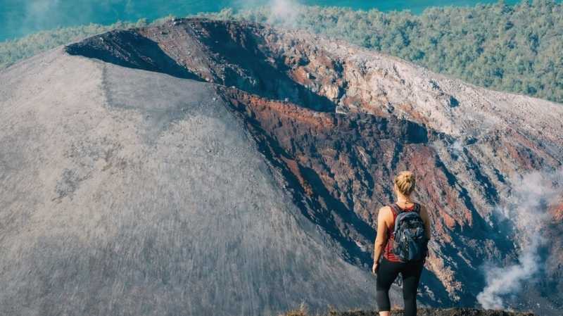 Hiker overlooks volcano crater
