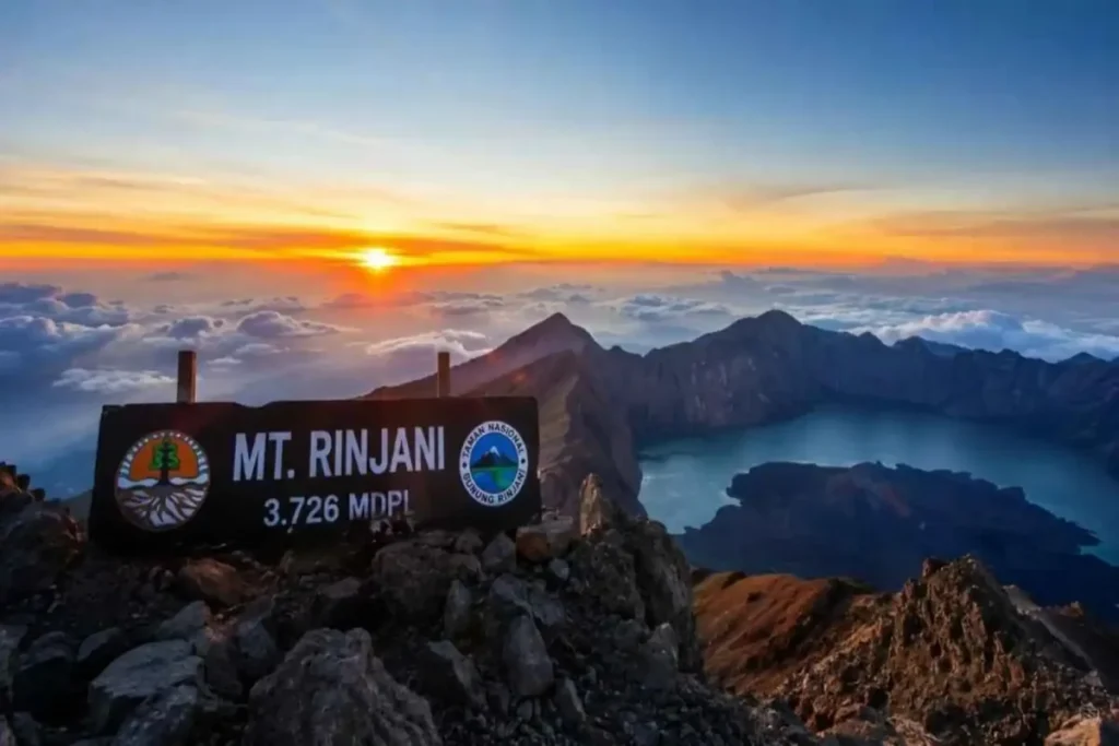 Sunrise at Mount Rinjani summit with Segara Anak Lake and mountain landscape